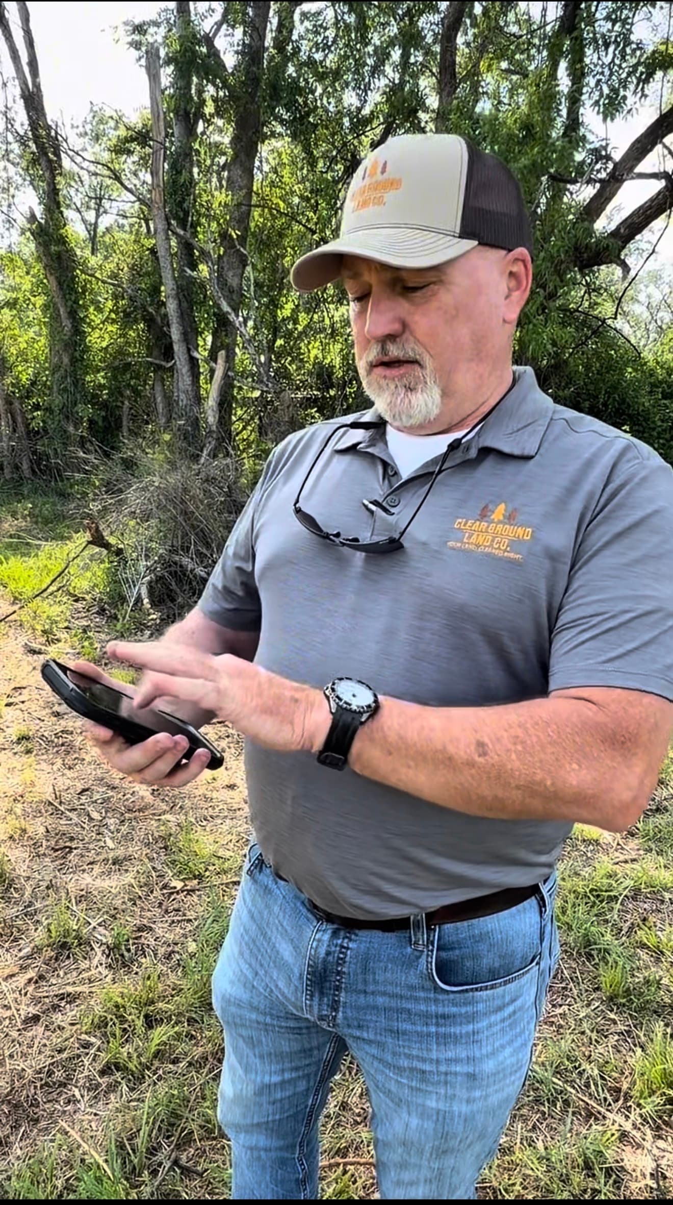 Jamie Crews, owner of Clear Ground Land Co., reviewing LandWorkPro on the jobsite